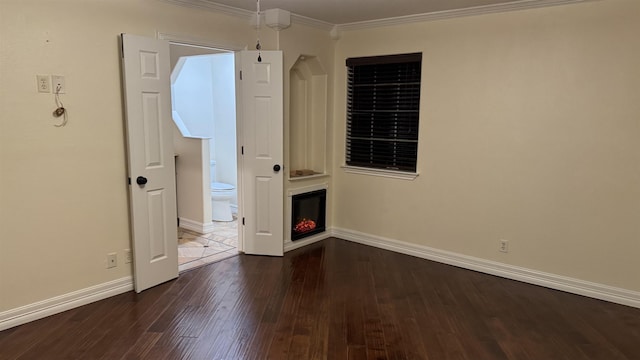 interior space with crown molding and dark hardwood / wood-style floors