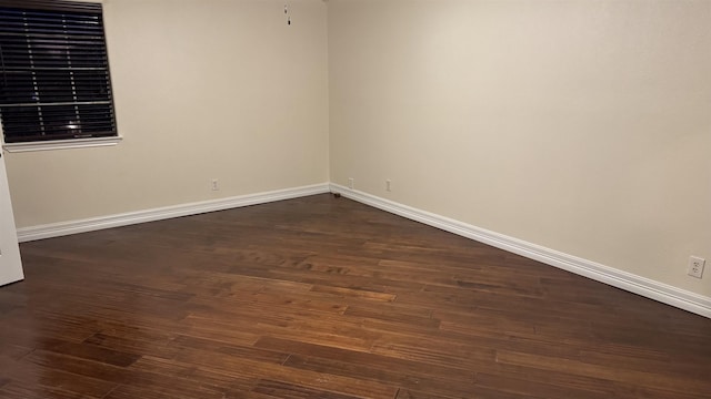 spare room featuring dark hardwood / wood-style floors