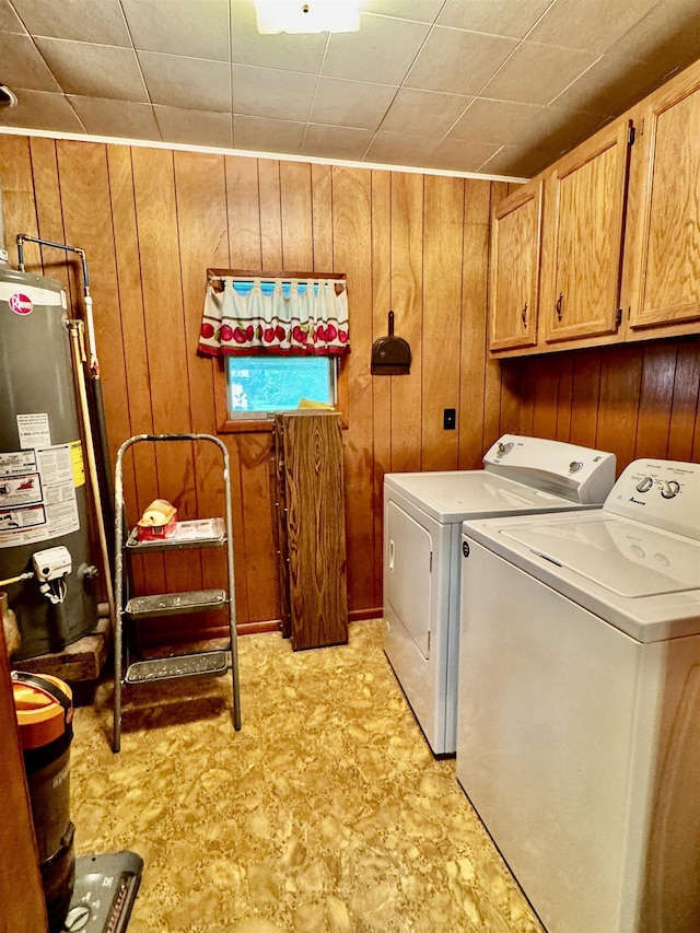3704 Nightingale St, Orange, TX 77630 - laundry area featuring cabinet space, water heater, washer and clothes dryer, and wood walls