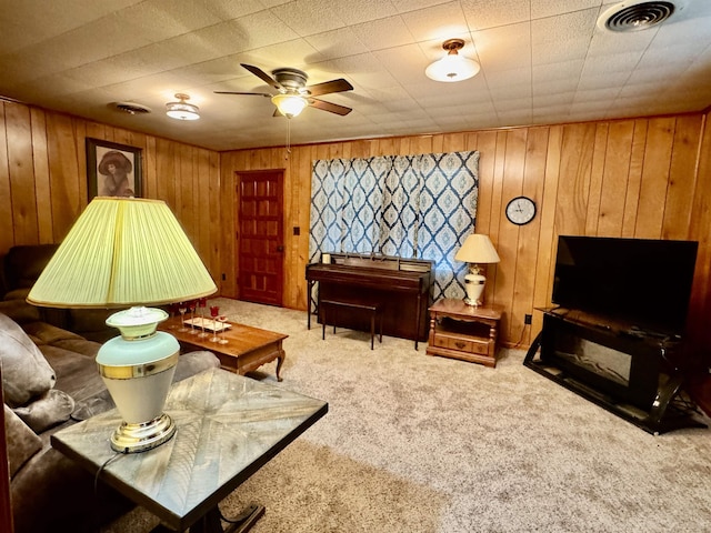3704 Nightingale St, Orange, TX 77630 - living area with carpet flooring, a ceiling fan, and wood walls