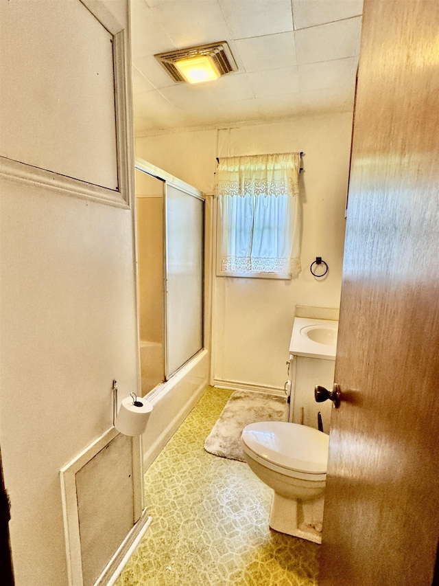 3704 Nightingale St, Orange, TX 77630 - full bathroom with toilet, vanity, bath / shower combo with glass door, and baseboards