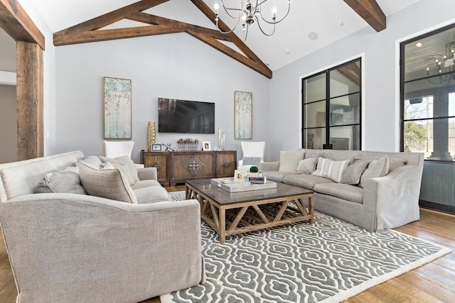 living room featuring wood finished floors, vaulted ceiling with beams, and an inviting chandelier