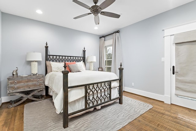 bedroom with recessed lighting, baseboards, and wood finished floors