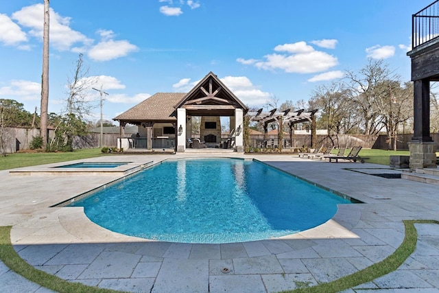 view of swimming pool with a fenced backyard, an outdoor stone fireplace, and a patio