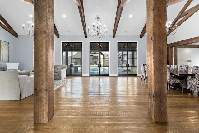 living area featuring high vaulted ceiling, beam ceiling, a chandelier, and wood finished floors