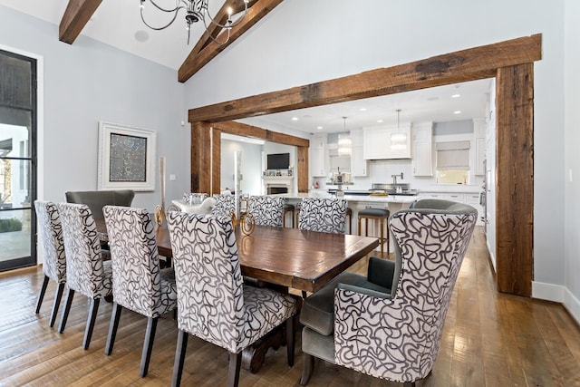 dining space with high vaulted ceiling, beam ceiling, a healthy amount of sunlight, and wood-type flooring