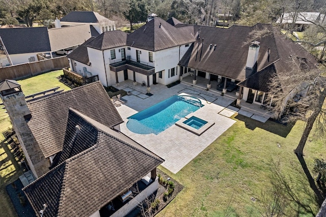 view of pool with a pool with connected hot tub, a patio area, a fenced backyard, and a yard