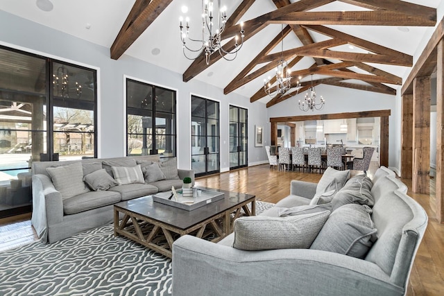 living room with high vaulted ceiling, wood finished floors, a chandelier, beamed ceiling, and baseboards