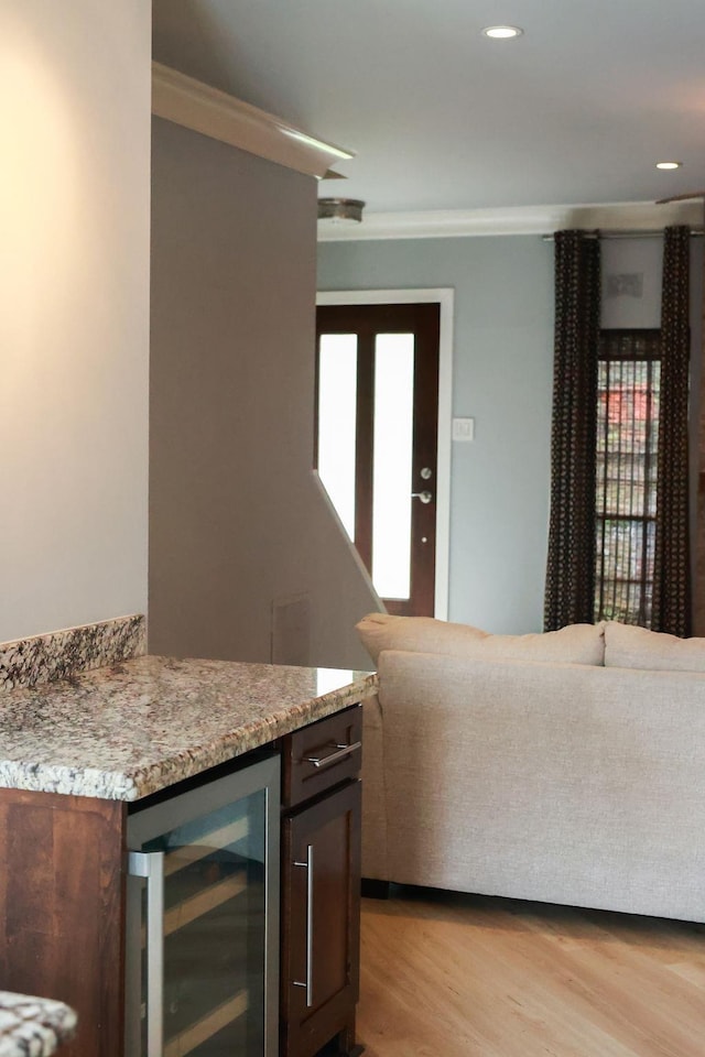 1620 Wellington Pl, Beaumont, TX 77706 - indoor dry bar with beverage cooler, ornamental molding, light wood-style flooring, and recessed lighting