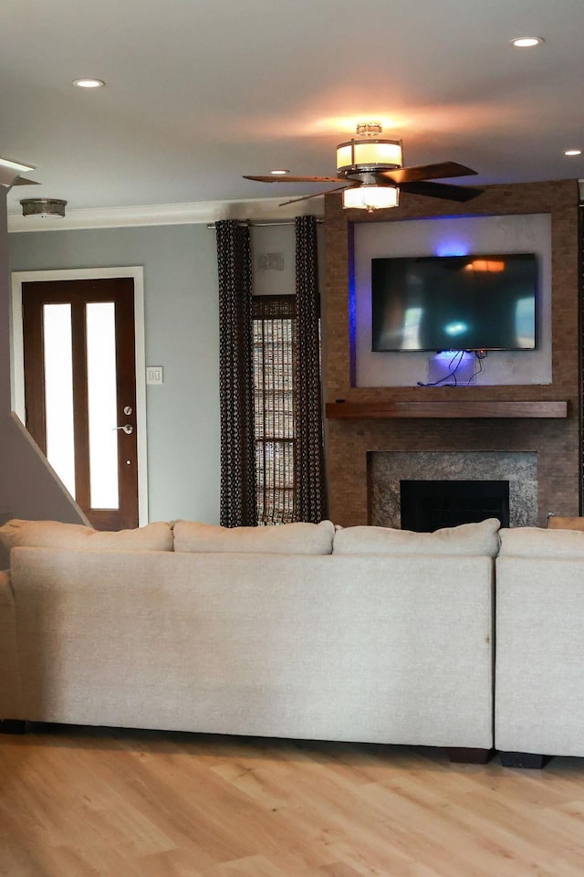 1620 Wellington Pl, Beaumont, TX 77706 - living room with a high end fireplace, wood finished floors, ceiling fan, recessed lighting, and crown molding