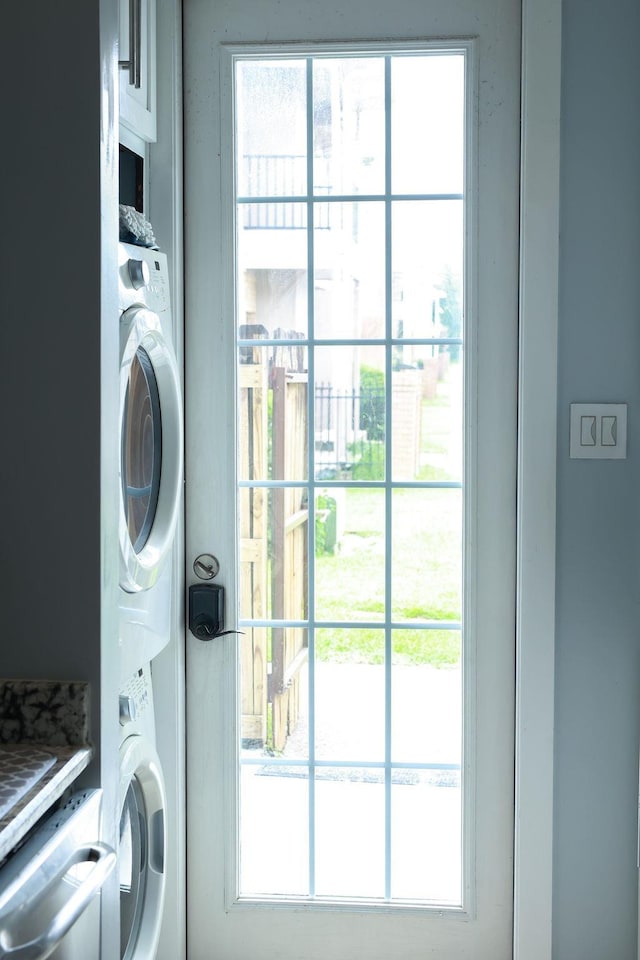 1620 Wellington Pl, Beaumont, TX 77706 - laundry room featuring stacked washer and clothes dryer and plenty of natural light