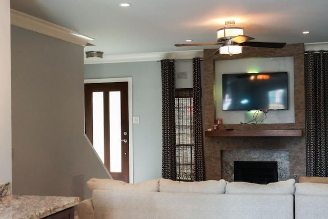 1620 Wellington Pl, Beaumont, TX 77706 - living room with crown molding, a ceiling fan, a high end fireplace, and recessed lighting