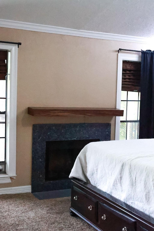 1620 Wellington Pl, Beaumont, TX 77706 - bedroom featuring ornamental molding, a high end fireplace, and carpet floors