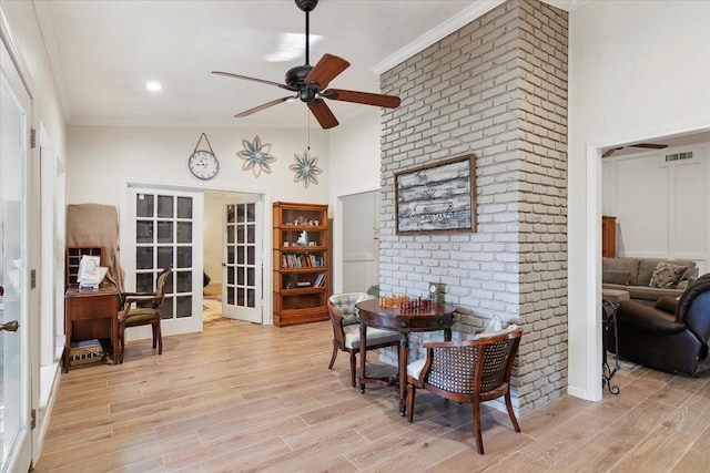 dining area featuring light wood-type flooring, ceiling fan, french doors, and ornamental molding