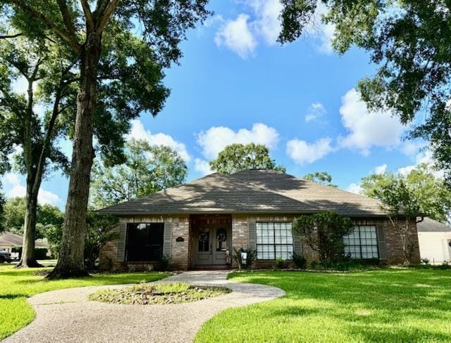 4715 Dunleith St, Beaumont, TX 77706 - view of front of property with brick siding and a front yard