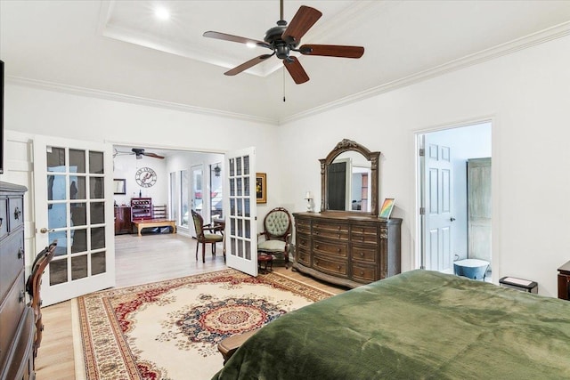 bedroom featuring ceiling fan, light hardwood / wood-style floors, ornamental molding, and french doors