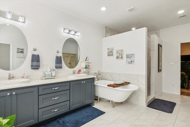 bathroom featuring crown molding, a bathing tub, tile walls, and vanity