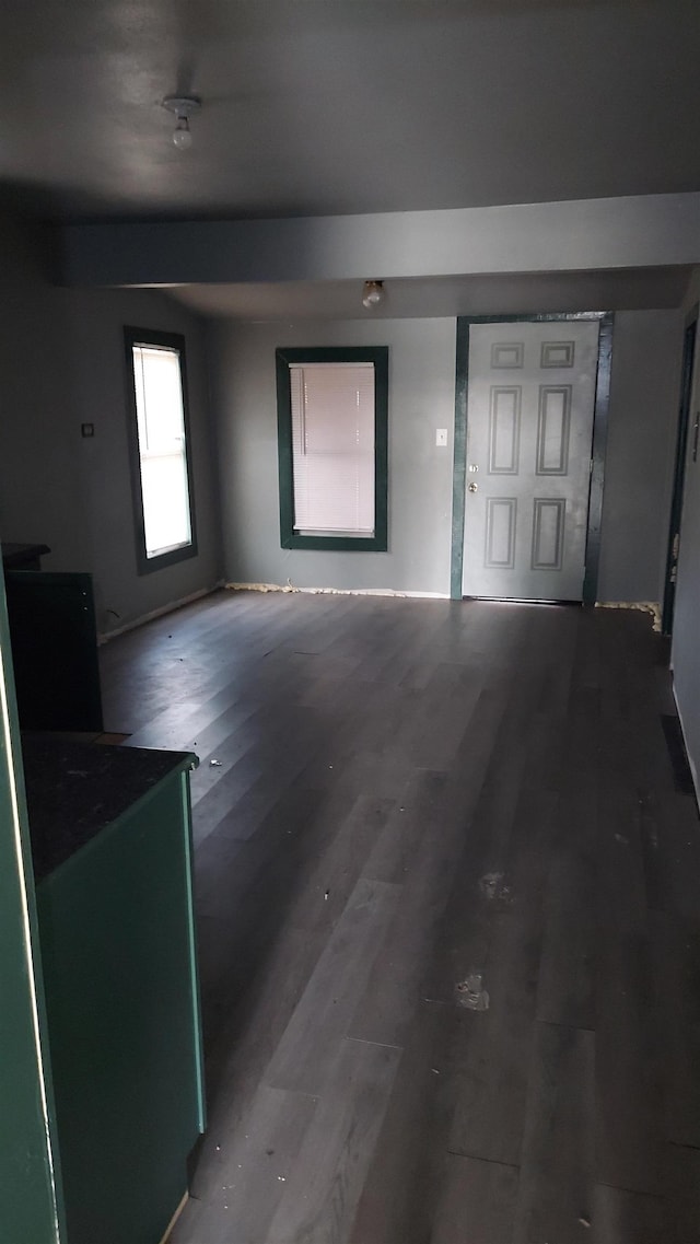 unfurnished living room featuring dark hardwood / wood-style flooring