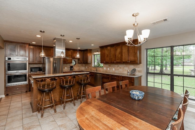 dining room with recessed lighting, a chandelier, light tile patterned flooring, and visible vents
