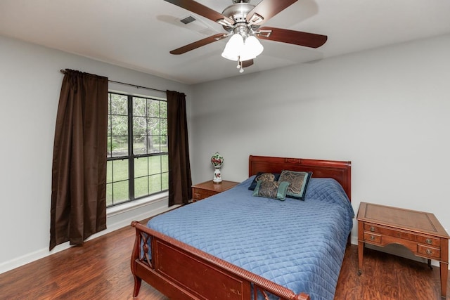 bedroom featuring baseboards, a ceiling fan, and wood finished floors