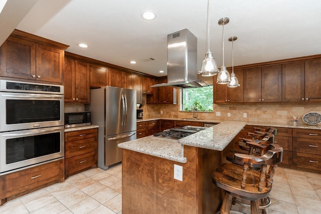 kitchen with appliances with stainless steel finishes, backsplash, island range hood, and light stone countertops