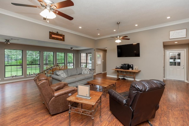 living area with ornamental molding, a ceiling fan, wood finished floors, and a wealth of natural light