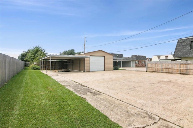 exterior space with a lawn, a garage, and a carport