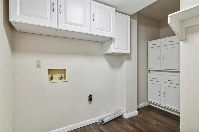 washroom with dark hardwood / wood-style floors, cabinets, and hookup for a washing machine