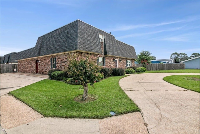 view of side of property with a lawn