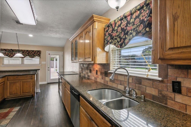 kitchen with sink, dark wood-type flooring, stainless steel dishwasher, backsplash, and a textured ceiling