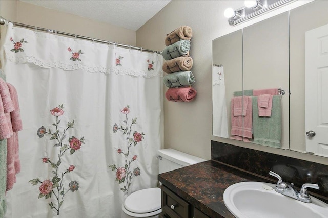 bathroom with vanity, a textured ceiling, toilet, and curtained shower