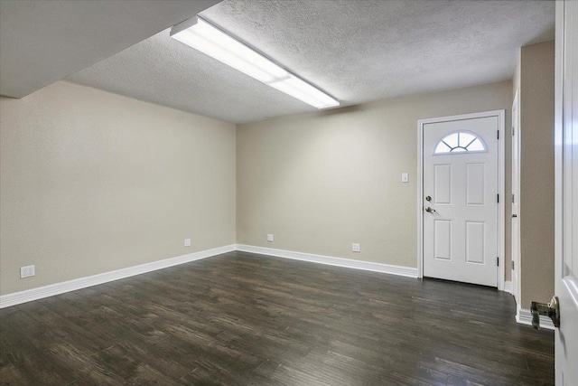 entryway with dark hardwood / wood-style floors and a textured ceiling