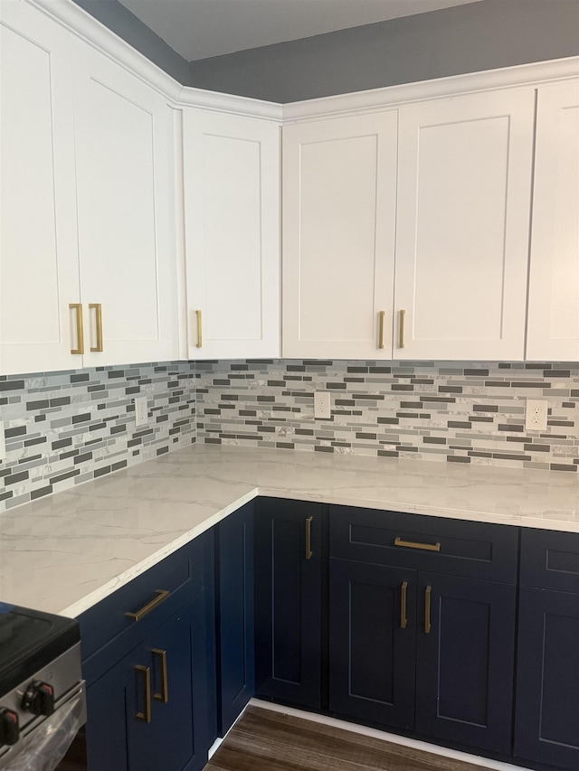 kitchen featuring tasteful backsplash, white cabinets, and dark hardwood / wood-style floors