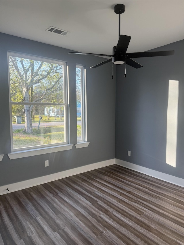 spare room with ceiling fan and dark hardwood / wood-style flooring