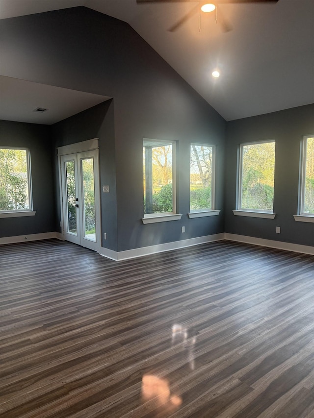 unfurnished living room with lofted ceiling, french doors, ceiling fan, and dark hardwood / wood-style floors