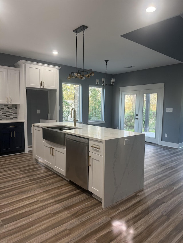 kitchen featuring hanging light fixtures, dark wood-type flooring, white cabinets, and stainless steel dishwasher