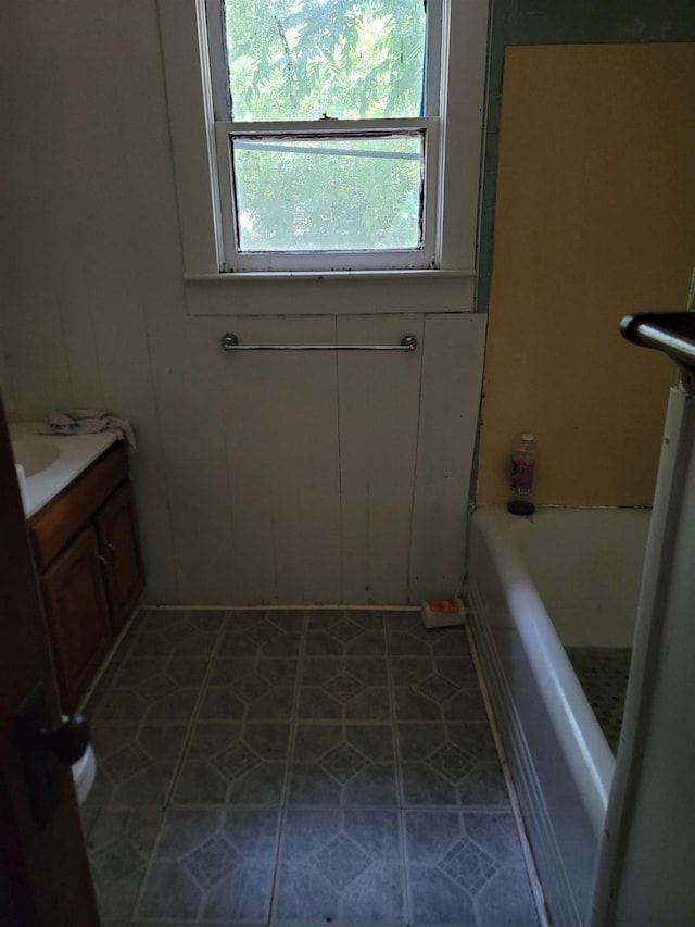 bathroom with vanity and a bathtub