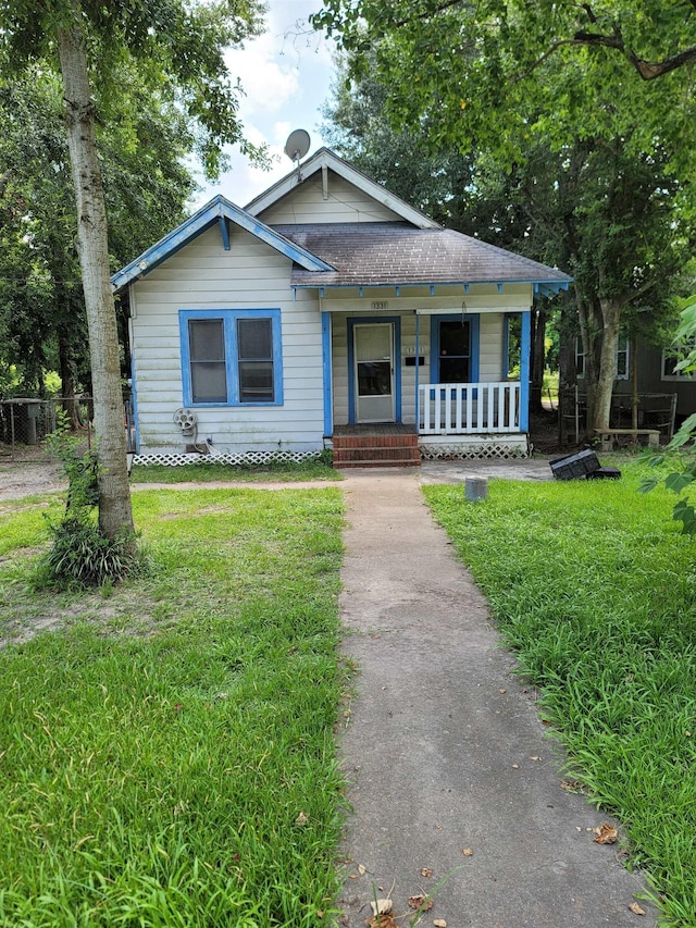 bungalow-style house featuring a porch and a front yard