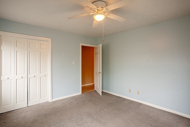 6215 Westgate Dr, Beaumont, TX 77706 - unfurnished bedroom featuring carpet flooring, a closet, baseboards, and a ceiling fan