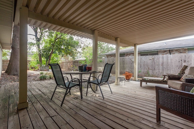 6215 Westgate Dr, Beaumont, TX 77706 - wooden deck with a fenced backyard and outdoor dining area