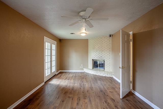 6215 Westgate Dr, Beaumont, TX 77706 - unfurnished living room featuring wood finished floors, baseboards, a ceiling fan, and a textured ceiling
