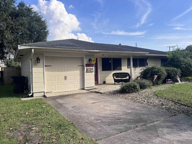 single story home featuring a front yard and a garage