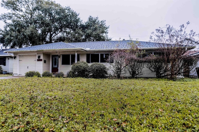 single story home with a front yard and a garage