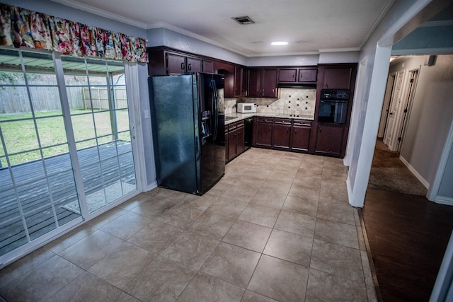 kitchen featuring dark brown cabinets, backsplash, light tile patterned floors, and black appliances