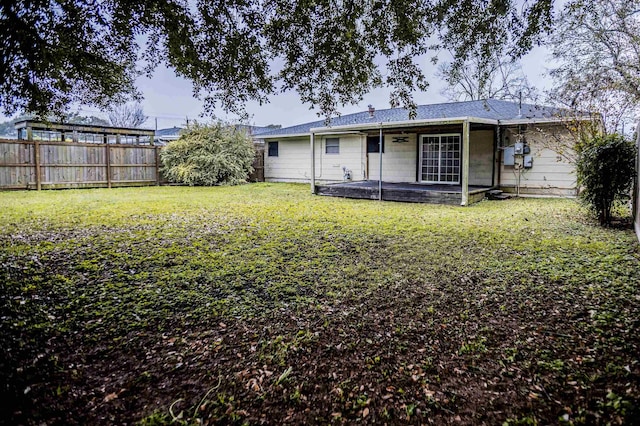 rear view of house with a lawn and a patio area