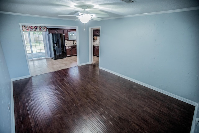 empty room with ceiling fan, light wood-type flooring, and crown molding