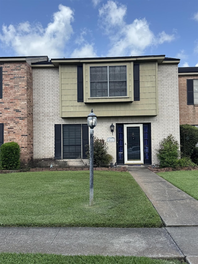 466 Yorktown Ln, Beaumont, TX 77707 - view of front of property featuring a front yard and brick siding