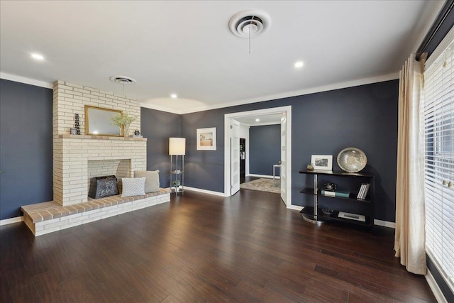 unfurnished living room featuring baseboards, crown molding, a brick fireplace, wood finished floors, and recessed lighting