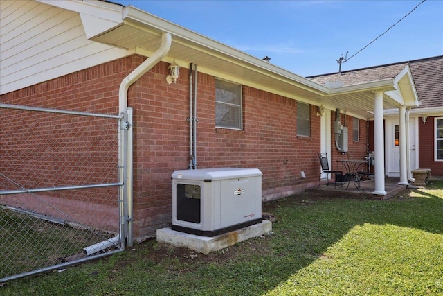 view of side of home featuring brick siding and a yard