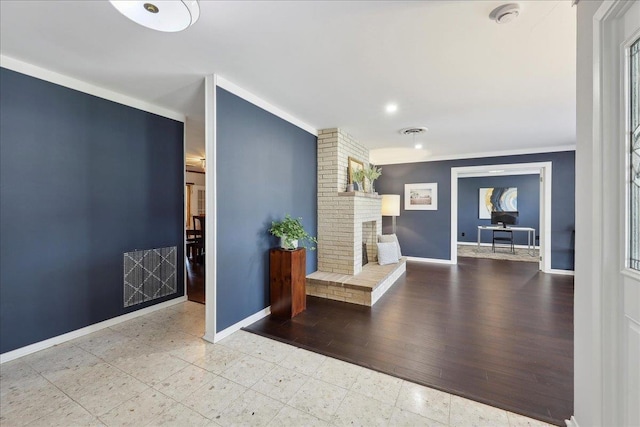 foyer featuring ornamental molding, baseboards, a fireplace, recessed lighting, and tile patterned flooring